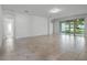 Spacious living room featuring tile floors, neutral walls, and sliding glass doors to outdoors at 4261 Sw 62Nd Loop, Ocala, FL 34474