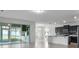 Spacious living room featuring tile floors, neutral walls, and access to kitchen at 4261 Sw 62Nd Loop, Ocala, FL 34474