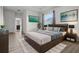 This main bedroom features a king bed, mounted TV and ensuite bathroom at 4261 Sw 62Nd Loop, Ocala, FL 34474