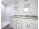 Elegant bathroom with double vanities, granite countertops, dual mirrors, and a tiled shower at 8881 Sw 138Th Ln, Ocala, FL 34473