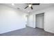 Bright bedroom featuring sleek gray flooring, white walls, ceiling fan, and a closet for storage at 8881 Sw 138Th Ln, Ocala, FL 34473