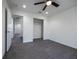 Bright bedroom featuring sleek gray flooring, white walls, ceiling fan, and a closet for storage at 8881 Sw 138Th Ln, Ocala, FL 34473