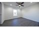 Bedroom featuring sleek gray flooring, white walls, ceiling fan, and a window with a view at 8881 Sw 138Th Ln, Ocala, FL 34473
