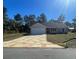 Front exterior of a cozy single-story home featuring a patterned driveway and manicured lawn at 8881 Sw 138Th Ln, Ocala, FL 34473