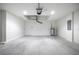 Spacious garage with concrete floor, insulated door, utility access, and white walls at 8881 Sw 138Th Ln, Ocala, FL 34473