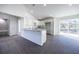 Well-lit kitchen featuring white cabinets, granite countertops, and modern appliances with gray vinyl flooring at 8881 Sw 138Th Ln, Ocala, FL 34473