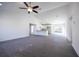 Bright, open-concept living space with gray vinyl floors, flowing into the kitchen and dining area at 8881 Sw 138Th Ln, Ocala, FL 34473