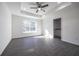 Bright main bedroom with large window offering natural light, complemented by a ceiling fan at 8881 Sw 138Th Ln, Ocala, FL 34473