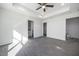 Spacious main bedroom featuring a tray ceiling, ceiling fan, and ensuite bathroom for ultimate comfort at 8881 Sw 138Th Ln, Ocala, FL 34473
