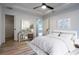 Bright bedroom with light floors and walls, tray ceiling, and modern decorative accents throughout at 8900 Sw 138Th Ln, Ocala, FL 34473