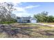 Spacious single-Gathering home on a sprawling lot surrounded by lush greenery and a long driveway at 8900 Sw 138Th Ln, Ocala, FL 34473