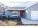 Charming single-story home featuring a red front door and a well-maintained, landscaped yard at 8900 Sw 138Th Ln, Ocala, FL 34473