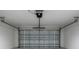 Close-up of a closed sectional garage door and operating mechanism at 8900 Sw 138Th Ln, Ocala, FL 34473