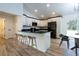 Modern kitchen with white cabinets, granite countertops, stainless appliances, and an eat-in island at 8900 Sw 138Th Ln, Ocala, FL 34473