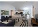 Open-concept living space with a kitchen, bar seating, dining area, and sleek furniture at 8900 Sw 138Th Ln, Ocala, FL 34473