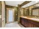 Bathroom with double sinks, wallpaper with a nature print, and white tile flooring at 2135 Se 12Th St, Ocala, FL 34471