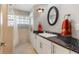 Bathroom with a granite countertop, white cabinets, and a glass block window at 2135 Se 12Th St, Ocala, FL 34471