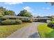 Charming single-story home with well-manicured landscaping and a curved driveway at 2135 Se 12Th St, Ocala, FL 34471