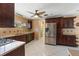 Well-lit kitchen featuring tiled floors, stainless steel appliances, and wood cabinets at 2135 Se 12Th St, Ocala, FL 34471