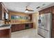 Well-lit kitchen with tiled floors, stainless steel appliances, and wood cabinets at 2135 Se 12Th St, Ocala, FL 34471