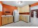 Bright kitchen with tile floors, wooden cabinets, and white appliances at 2135 Se 12Th St, Ocala, FL 34471