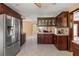 Spacious kitchen with stainless steel refrigerator and rich, dark wood cabinetry at 2135 Se 12Th St, Ocala, FL 34471