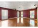 Bright living room featuring hardwood floors, textural walls and several windows for natural light at 2135 Se 12Th St, Ocala, FL 34471