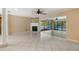 Spacious living area features a fireplace, tile flooring, and sliding glass doors to the pool area at 2135 Se 12Th St, Ocala, FL 34471