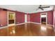 Spacious living room with gleaming hardwood floors, ceiling fan and white trim at 2135 Se 12Th St, Ocala, FL 34471