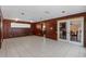 Spacious living room featuring wood paneled walls and access to kitchen and dining area at 2135 Se 12Th St, Ocala, FL 34471