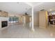 Open-concept living area features a stone fireplace, tile flooring, and access to the kitchen at 2135 Se 12Th St, Ocala, FL 34471