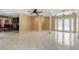 Open-concept living area with tile flooring, decorative columns, and lots of natural light at 2135 Se 12Th St, Ocala, FL 34471
