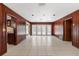 Expansive living room with wood paneled walls and access to kitchen and backyard at 2135 Se 12Th St, Ocala, FL 34471