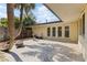 Spacious backyard patio with a grill, a fire pit, and palm trees at 2135 Se 12Th St, Ocala, FL 34471