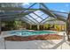A sparkling screened-in pool is surrounded by a large deck perfect for outdoor entertaining at 2135 Se 12Th St, Ocala, FL 34471