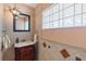 Elegant powder room featuring a sink with decorative tiles and an ornate mirror at 2135 Se 12Th St, Ocala, FL 34471
