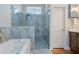 Luxurious primary bathroom featuring a jacuzzi tub and marble shower with dual shower heads at 3943 Nw 219Th Street Rd, Micanopy, FL 32667