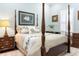Bedroom with a four poster bed, plush pillows, wooden furnishings, and serene decor at 3943 Nw 219Th Street Rd, Micanopy, FL 32667