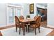 Dining room features stylish wooden table, designer chairs, wood floors, natural light, and neutral colors at 3943 Nw 219Th Street Rd, Micanopy, FL 32667