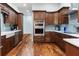 Spacious kitchen showcasing the stainless steel appliances, custom cabinets and beautiful wood floors at 3943 Nw 219Th Street Rd, Micanopy, FL 32667