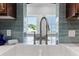 Kitchen farmhouse sink with stylish faucet overlooks the outdoor views through an open and airy window at 3943 Nw 219Th Street Rd, Micanopy, FL 32667