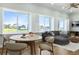 Bright open living room with large windows, plantation shutters, modern furnishings, and views of the water at 3943 Nw 219Th Street Rd, Micanopy, FL 32667