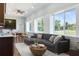 Bright living room with a comfortable sectional couch, modern furniture, and large windows at 3943 Nw 219Th Street Rd, Micanopy, FL 32667