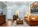 Cozy living room features wood floors, plantation shutters, stylish furniture and natural light at 3943 Nw 219Th Street Rd, Micanopy, FL 32667