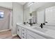 Modern bathroom featuring a double vanity, sleek black fixtures, and large mirror at 716 Golfview St, Orlando, FL 32804