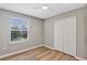 Neutral bedroom featuring luxury vinyl plank flooring and a closet at 716 Golfview St, Orlando, FL 32804