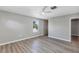 Spacious bedroom with a ceiling fan, window, and wood-look floors at 716 Golfview St, Orlando, FL 32804