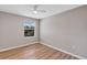 Bright bedroom features a ceiling fan, window, and modern flooring for comfortable living at 716 Golfview St, Orlando, FL 32804