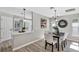 Open dining room with table, modern lighting, and partial view of kitchen and living room at 716 Golfview St, Orlando, FL 32804