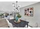 Bright dining area with modern light fixture is adjacent to an inviting living room at 716 Golfview St, Orlando, FL 32804